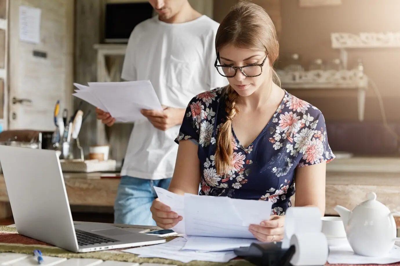 A couple working on their budget together in the kitchen.