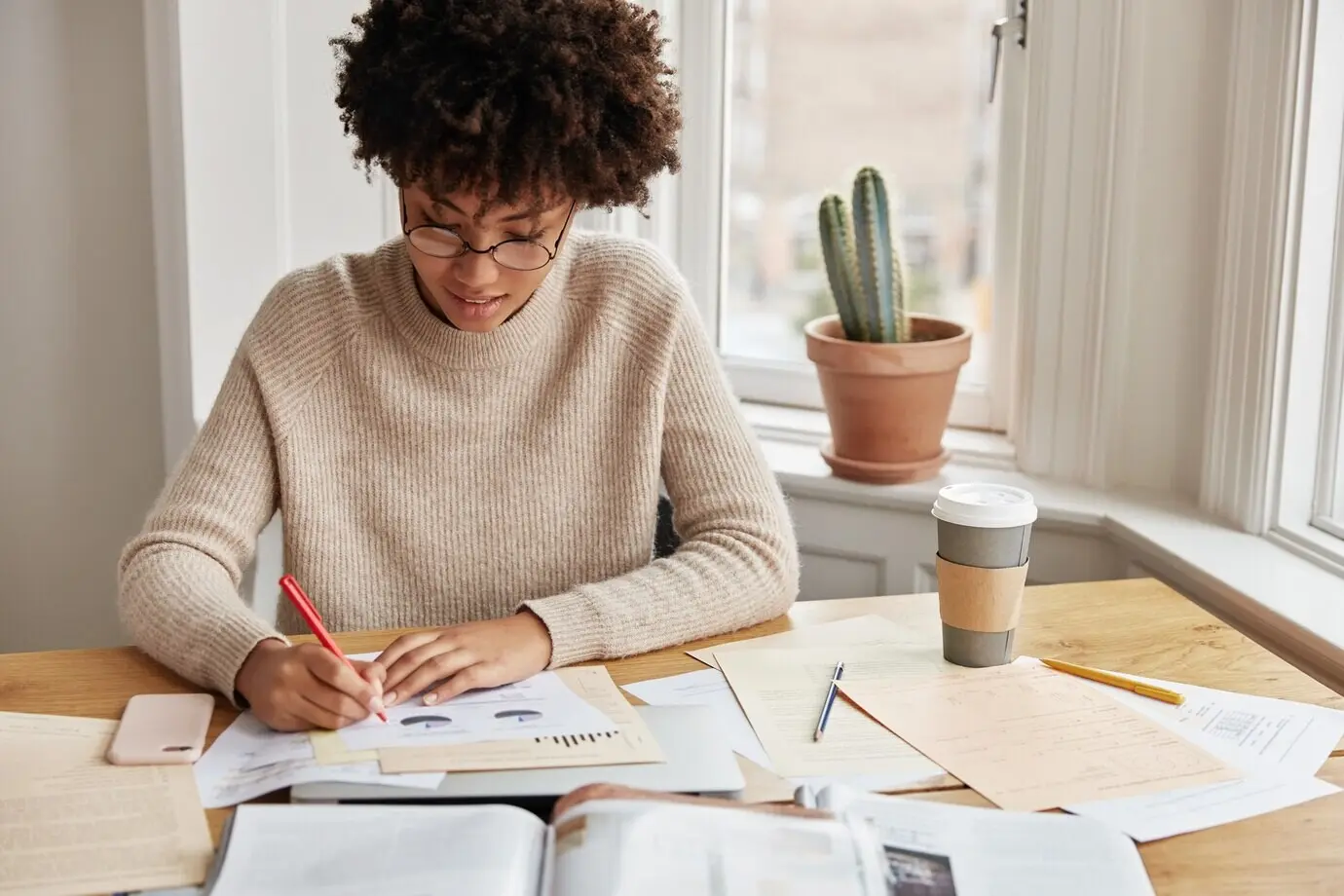 Smart, busy young woman accountant working from home