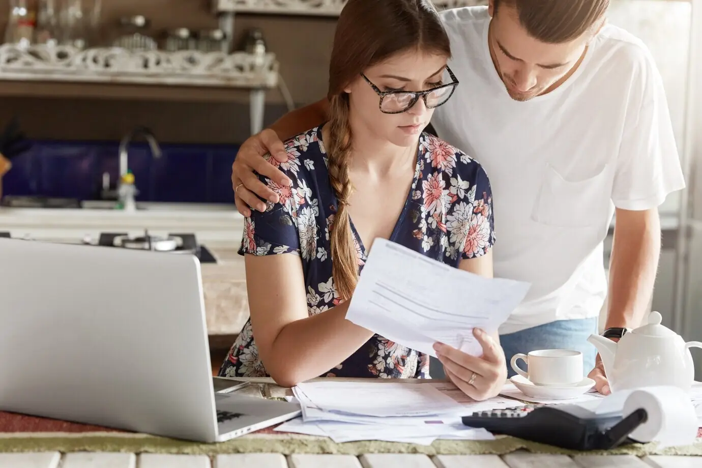 A couple managing a budget together in the kitchen